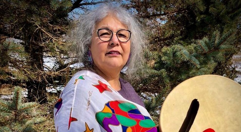 Portrait of Elder Lorraine Whitman-Peters holding a hand drum